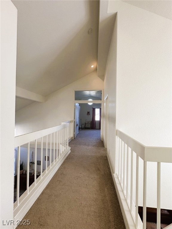 hall featuring carpet and vaulted ceiling