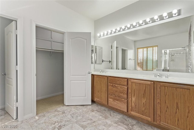 bathroom featuring an enclosed shower and vanity