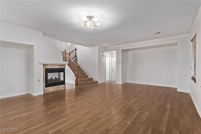 unfurnished living room with a fireplace and hardwood / wood-style flooring