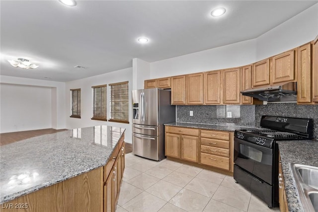 kitchen featuring stainless steel fridge, black range with gas cooktop, sink, tasteful backsplash, and light tile patterned flooring