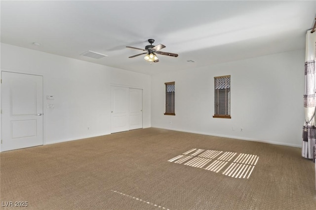 empty room with carpet flooring and ceiling fan