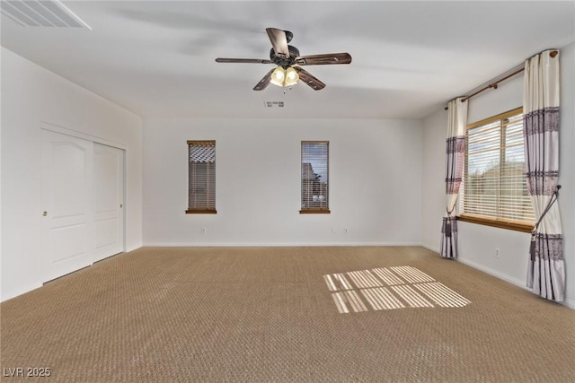 carpeted empty room featuring ceiling fan