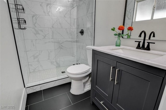 bathroom featuring toilet, a tile shower, tile patterned flooring, and vanity