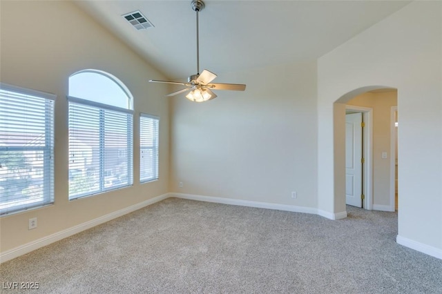 carpeted empty room featuring high vaulted ceiling and ceiling fan