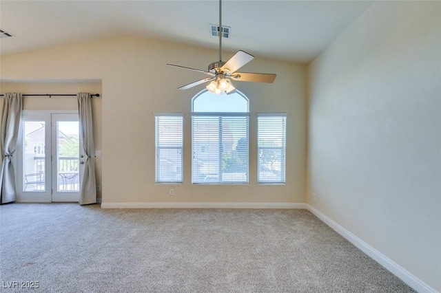 empty room featuring lofted ceiling, ceiling fan, and light colored carpet