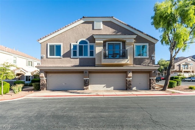 view of front of home featuring a garage and a balcony