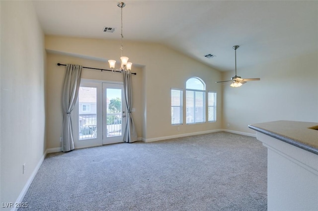 unfurnished room featuring lofted ceiling, carpet flooring, and ceiling fan with notable chandelier