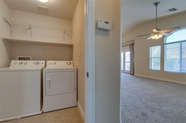 laundry room with light carpet, ceiling fan, and washer and clothes dryer