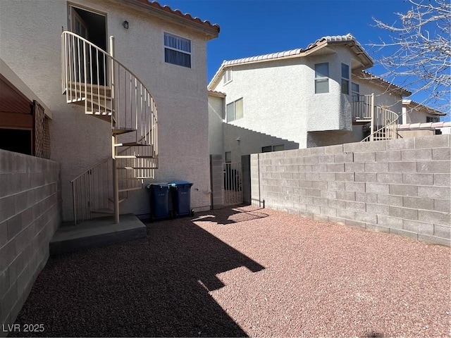 view of yard featuring fence and stairs
