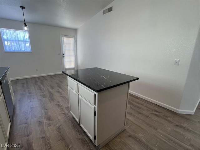 kitchen with a center island, pendant lighting, dark wood-style flooring, visible vents, and white cabinets