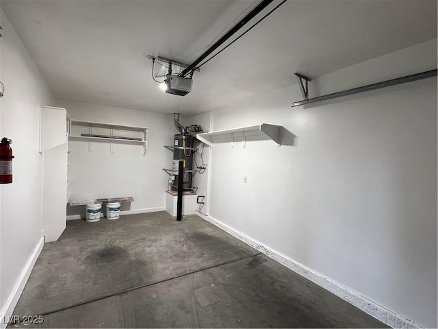 garage featuring water heater, baseboards, and a garage door opener