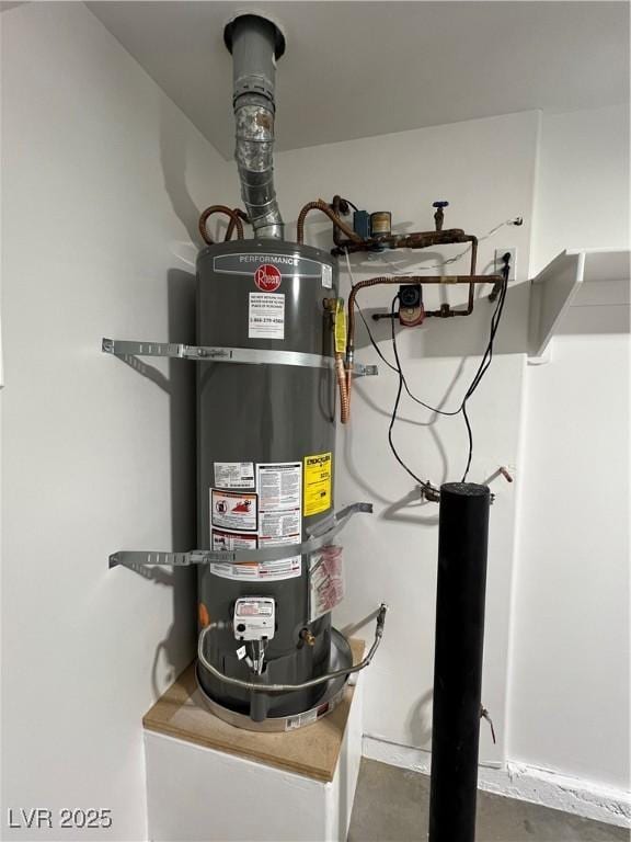 utility room featuring strapped water heater