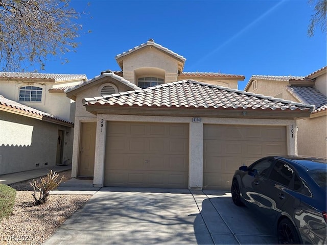 mediterranean / spanish-style house with a garage, concrete driveway, a tile roof, and stucco siding