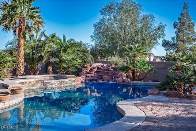 view of swimming pool with a fenced in pool, an in ground hot tub, and fence