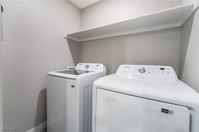 laundry room with washing machine and clothes dryer