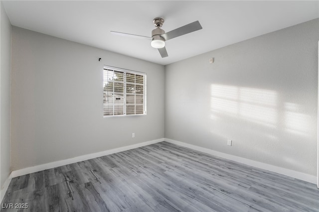 spare room with ceiling fan and wood-type flooring