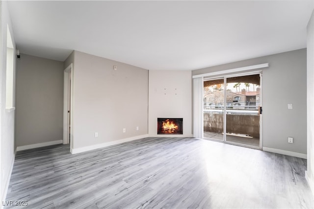 unfurnished living room featuring hardwood / wood-style flooring