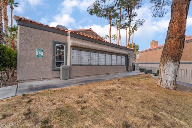 view of side of home featuring a lawn