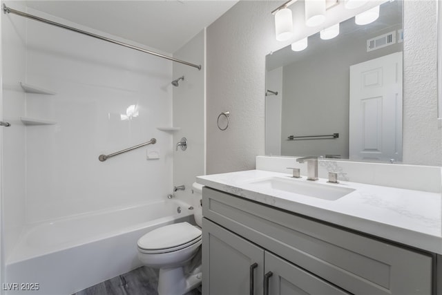 full bathroom featuring toilet, vanity, hardwood / wood-style floors, and shower / bathing tub combination