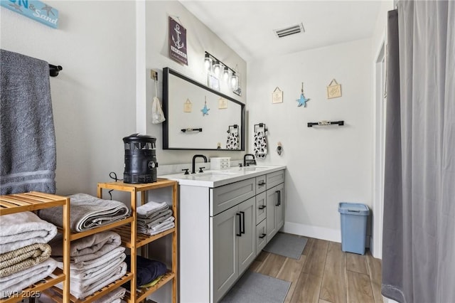 bathroom with vanity and wood-type flooring