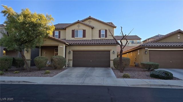 view of front of property featuring stucco siding, a garage, concrete driveway, and a tile roof