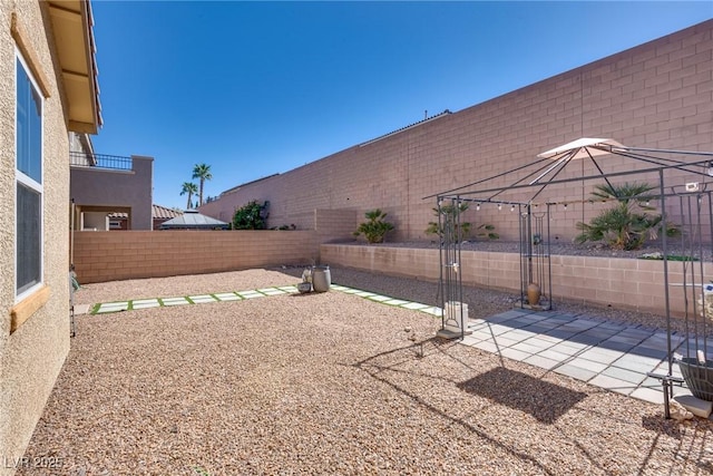 view of yard featuring a patio area and a fenced backyard