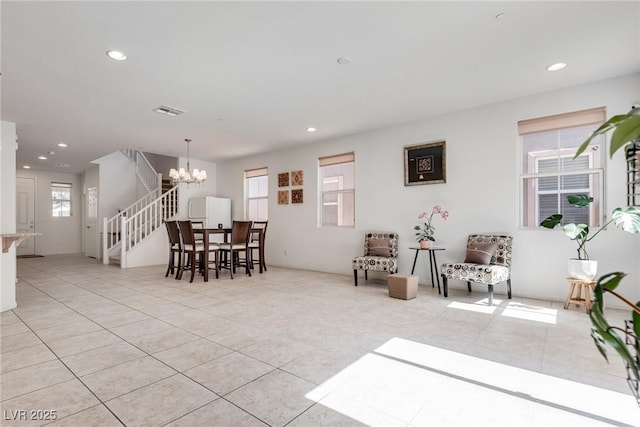 interior space featuring a notable chandelier, stairway, light tile patterned floors, and recessed lighting