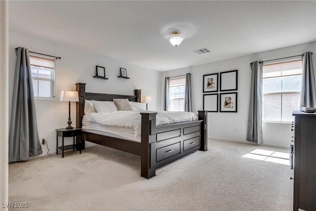 bedroom featuring light carpet and visible vents