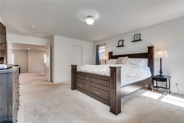 bedroom with visible vents and light colored carpet