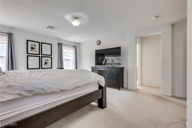 bedroom with light colored carpet and visible vents