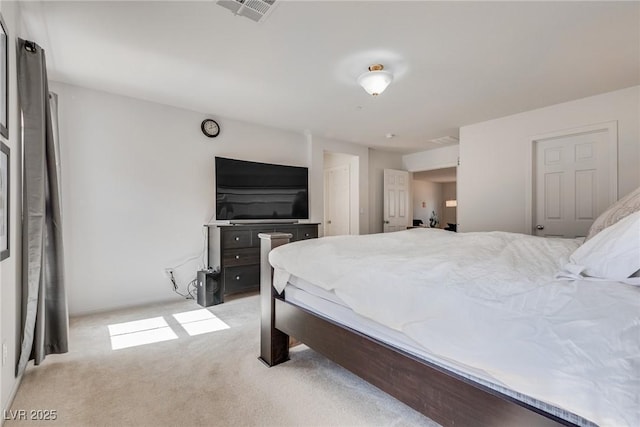 carpeted bedroom featuring visible vents