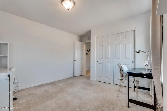 office with baseboards, carpet floors, and washer / dryer