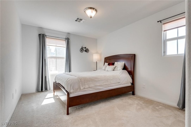 carpeted bedroom with visible vents and baseboards