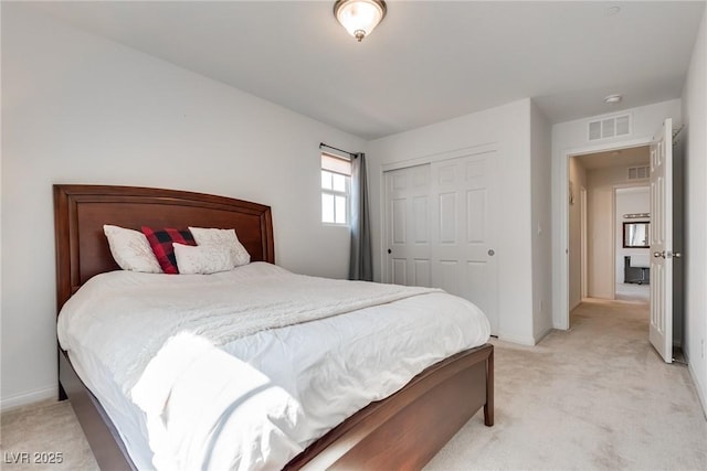 bedroom with visible vents, baseboards, light colored carpet, and a closet