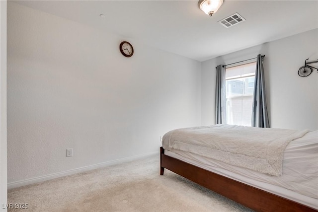 carpeted bedroom with visible vents and baseboards