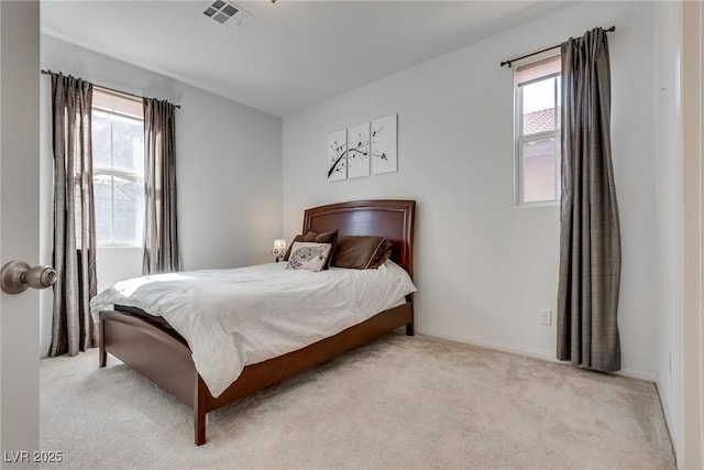 carpeted bedroom with baseboards and visible vents