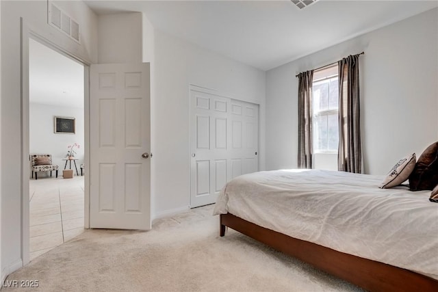 bedroom with light carpet and visible vents