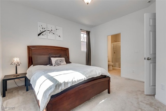 bedroom with connected bathroom, baseboards, and light colored carpet