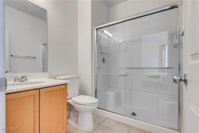 bathroom with vanity, toilet, a shower stall, and tile patterned flooring