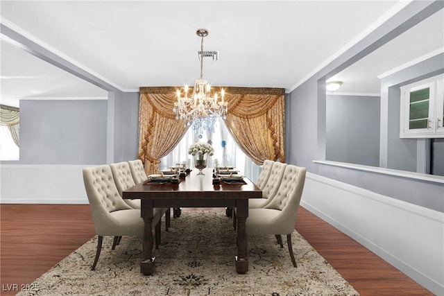 1301 E St Louis Ave Unit C, Las Vegas, NV 89104 - dining room featuring a chandelier, crown molding, baseboards, and wood finished floors