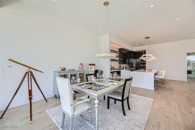 dining room with light wood-style flooring and recessed lighting