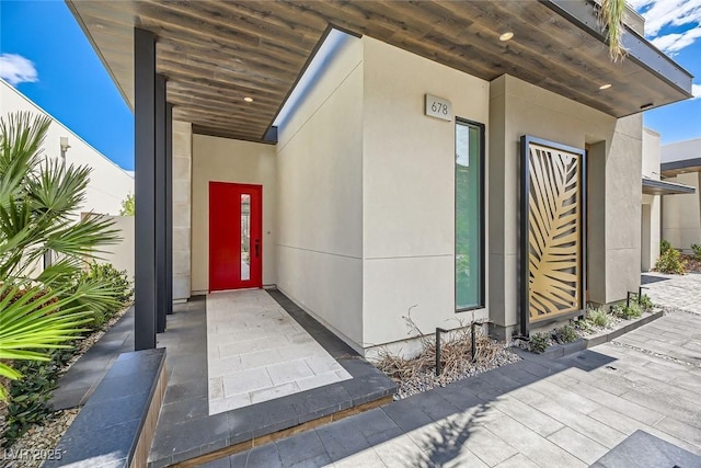 entrance to property featuring stucco siding