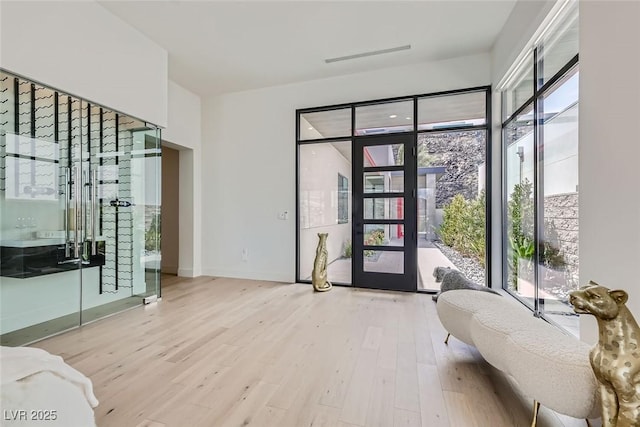 interior space with wood finished floors and baseboards