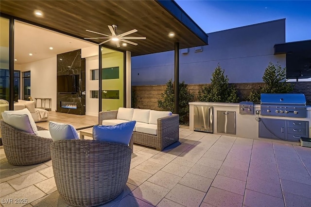 view of patio with an outdoor living space, grilling area, an outdoor kitchen, and ceiling fan