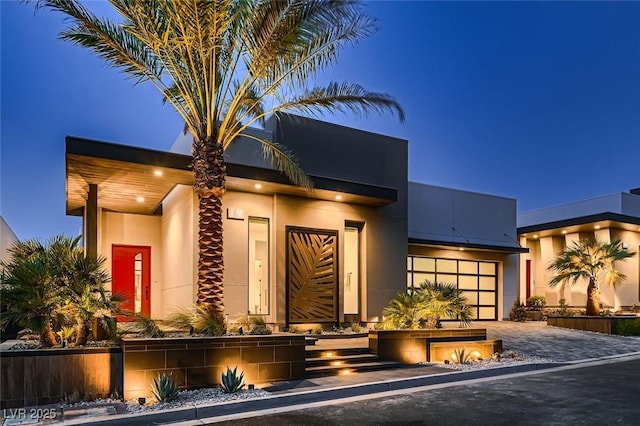 view of front facade featuring stucco siding and decorative driveway