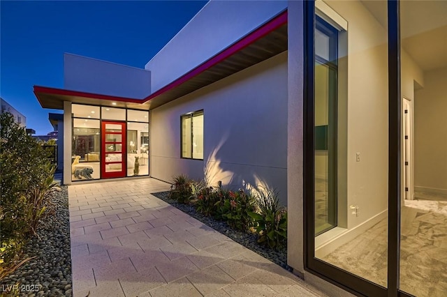 property entrance with stucco siding