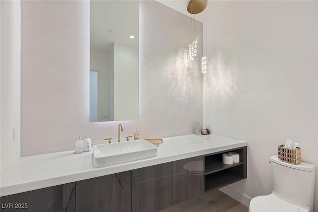 bathroom featuring toilet and vanity