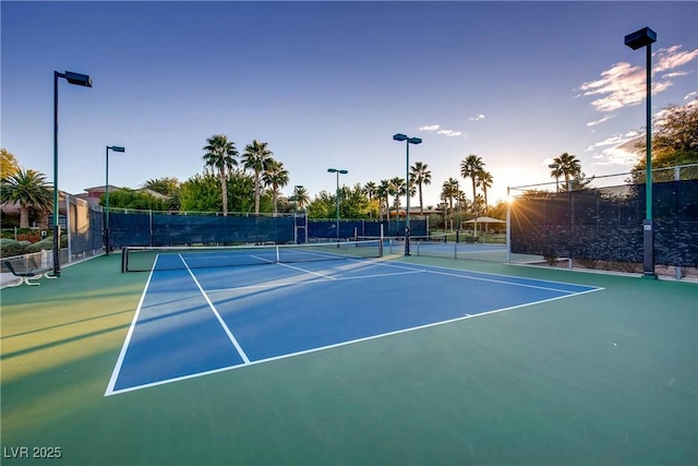 view of tennis court with fence