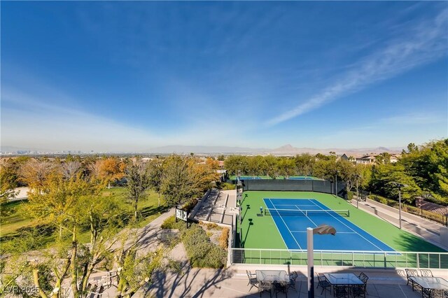 view of tennis court featuring fence