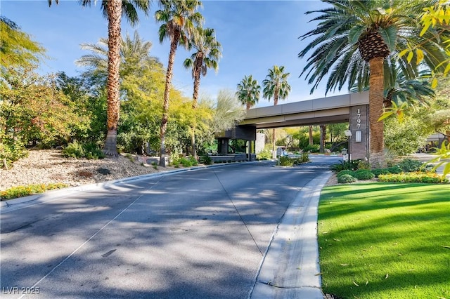 view of street featuring curbs and a gated entry